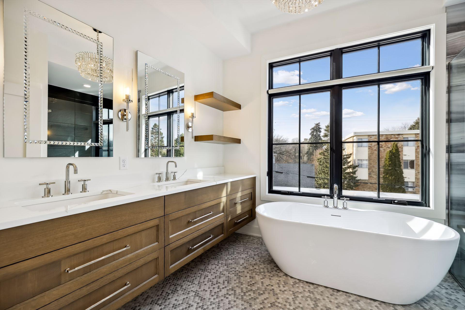 Spa-like primary bath with heated floors, dual vanity areas, large soaker tub, and curbless walk-in shower