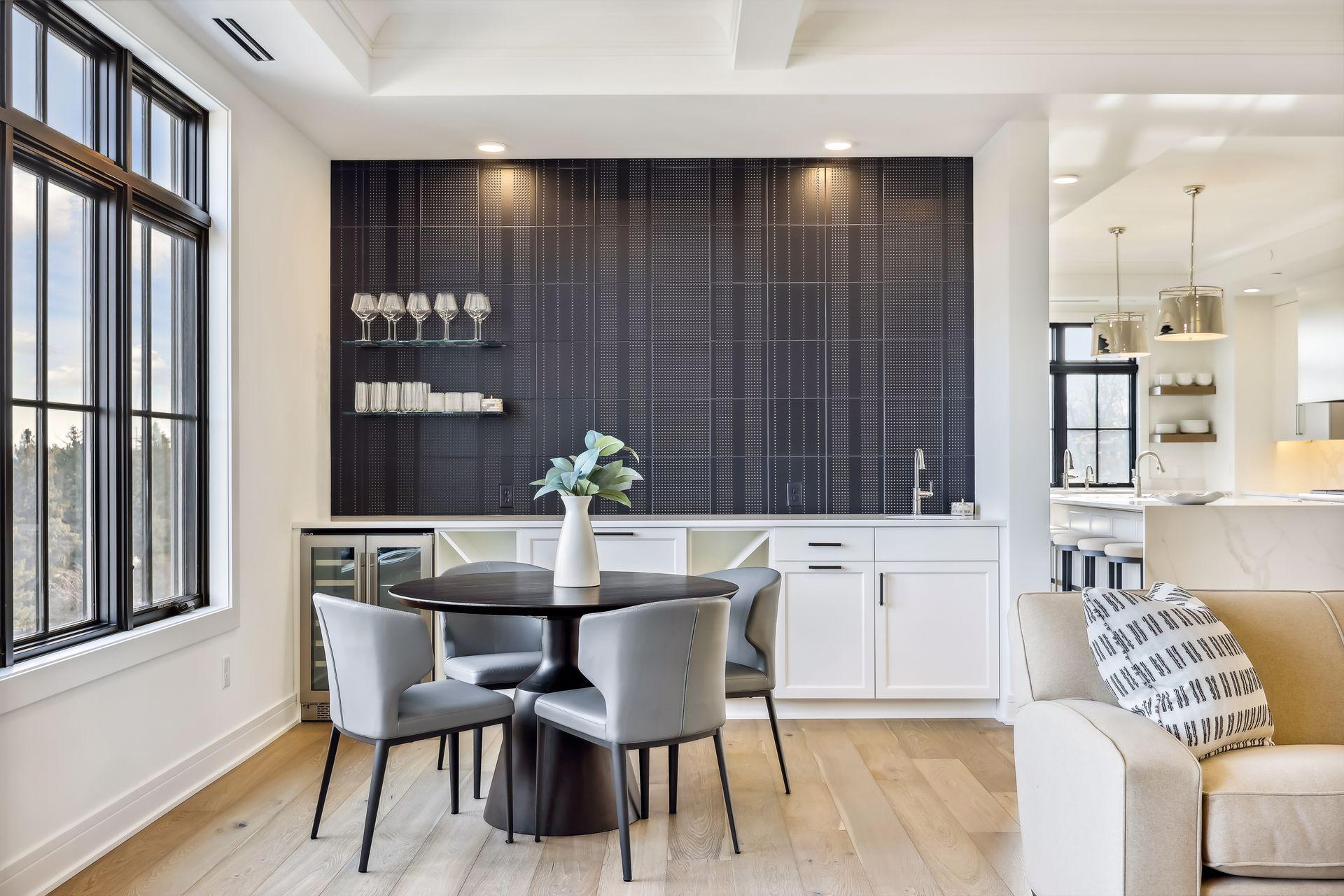 The bar area features floating shelves, sink, dual zone beverage center and a great backdrop for some impressive artwork