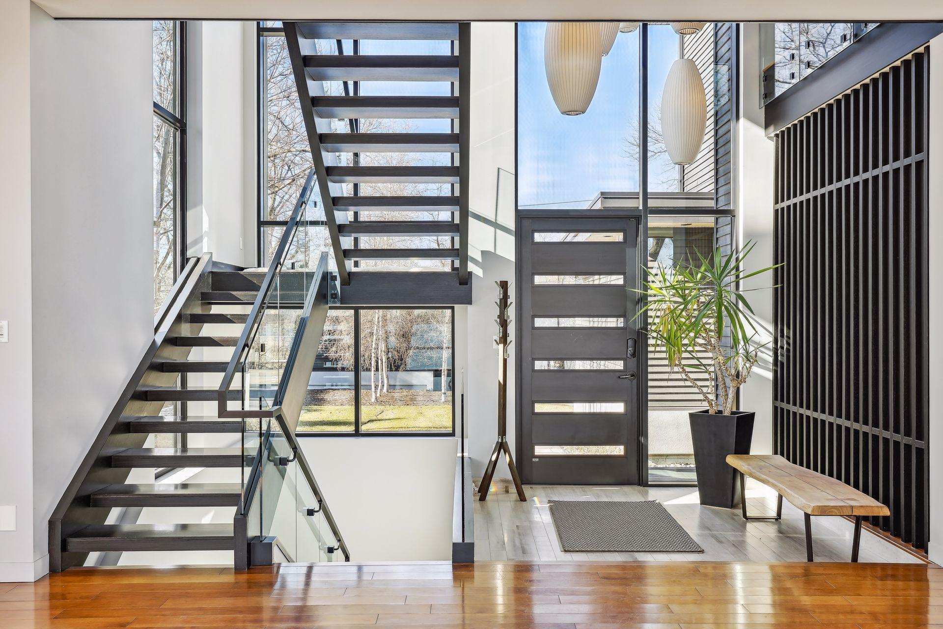 Custom, floating staircase allows for natural light to flow through home
