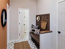 Mud room with built-in bench, walk-in closet, bathroom, and pantry storage