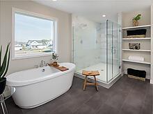 Owner's bath with soaking tub and large tiled shower