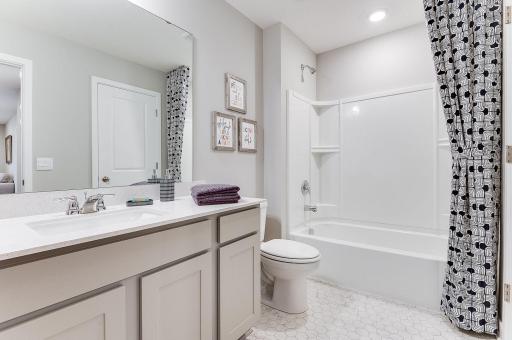 Upper level full bath with quartz countertops, a large vanity, and a linen closet! (Model photo, colors may vary.)