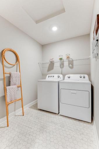 Spacious, dedicated laundry room on upper level provides ample storage. (Model photo, colors may vary.)