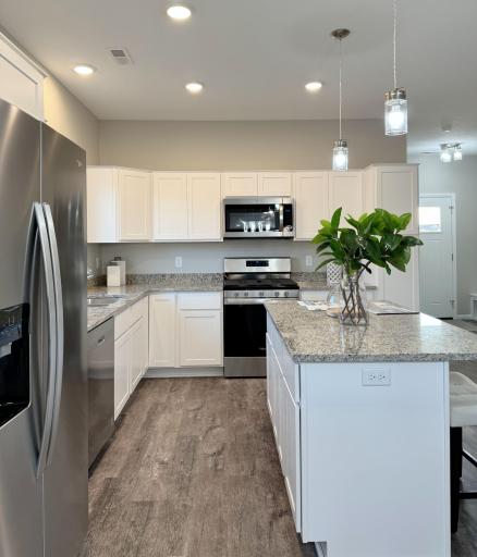 Gorgeous open design with great natural light, fireplace, soft close cabinets, granite countertops, stainless steel appliances including gas stove, and a center island with breakfast bar, and pantry!