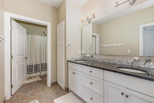 Bathroom on upper level with dual sinks, dual-private toilets and shower/tubs.