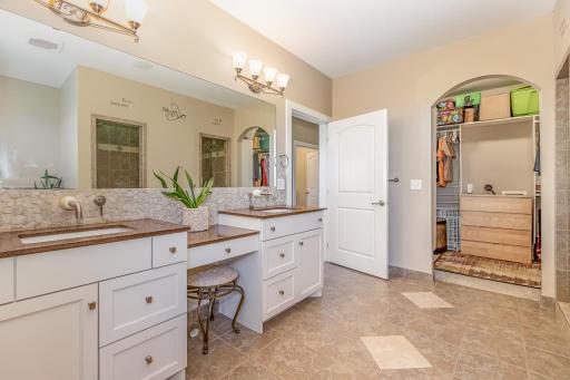 Dual sinks and showers in the primary bedroom's private bathroom
