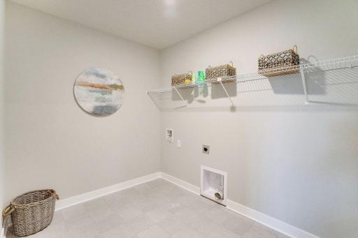 Look at this laundry room! Space for folding and more storage.
