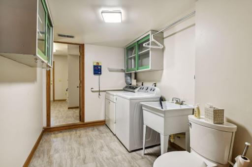 Generously sized laundry room (off of entry foyer) 1/4 bath within (that could be divided to create a private powder room 1/2 bath).