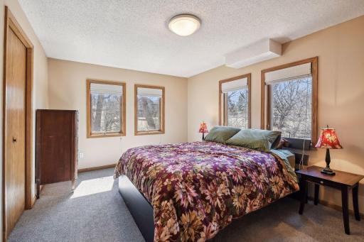 Lovely lower primary bedroom with a lovely view of the pond and preserve adjacent to home. Lower primary offers large ensuite 3/4 bath and large walk-in closet.