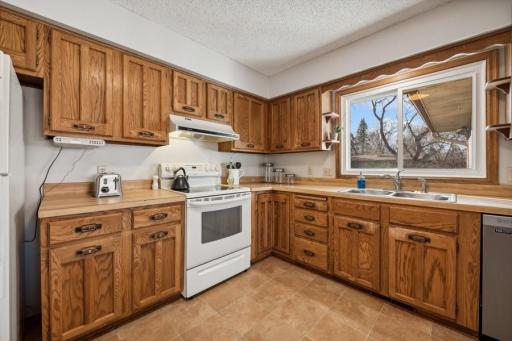 Kitchen is well sized and features oak cabinetry that provides abundant storage.