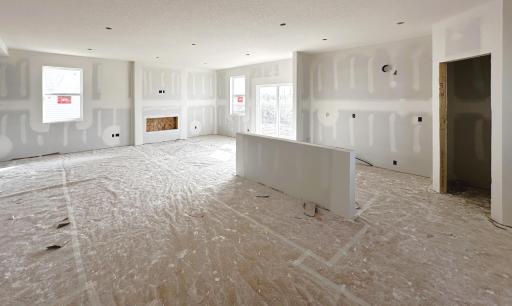 Pardon the mess! Home is under construction. Picture is of actual home. Family room is highlighted by electric fireplace.