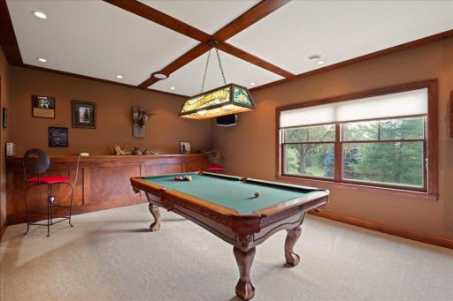 Billiard room with custom woodwork currently features an office and could be used as a bedroom