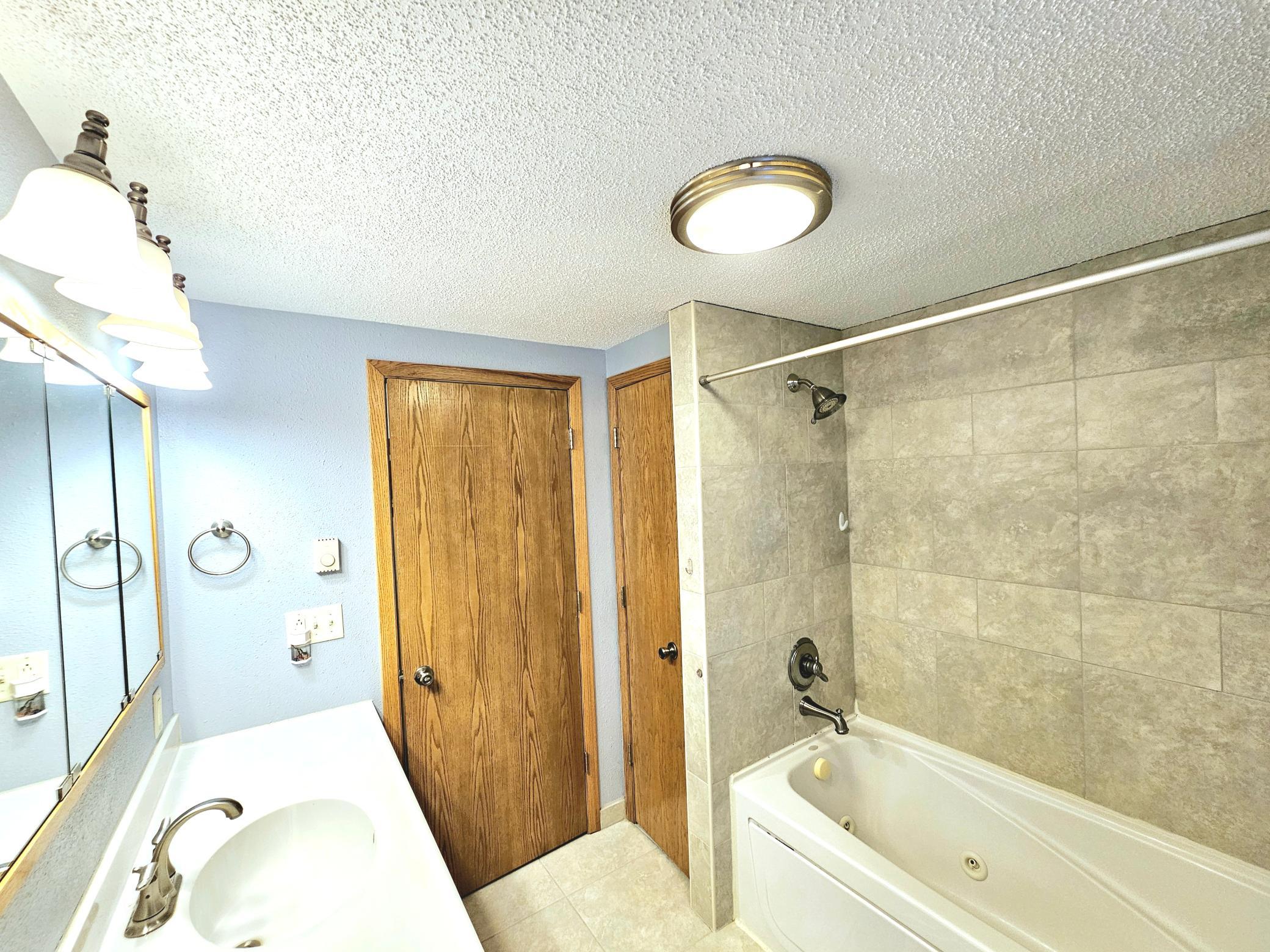 main flr bath, tiled shower/ jetted bathtub