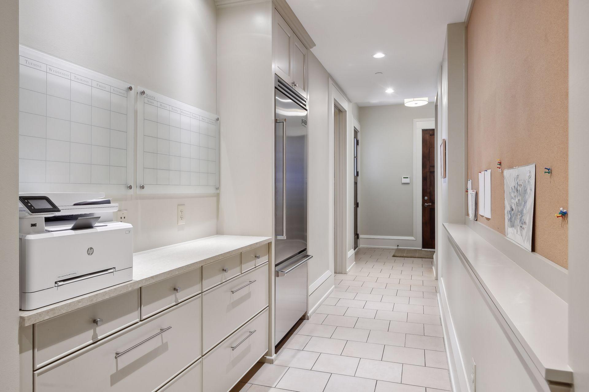 Mud room area with full fridge and 2 mudrooms