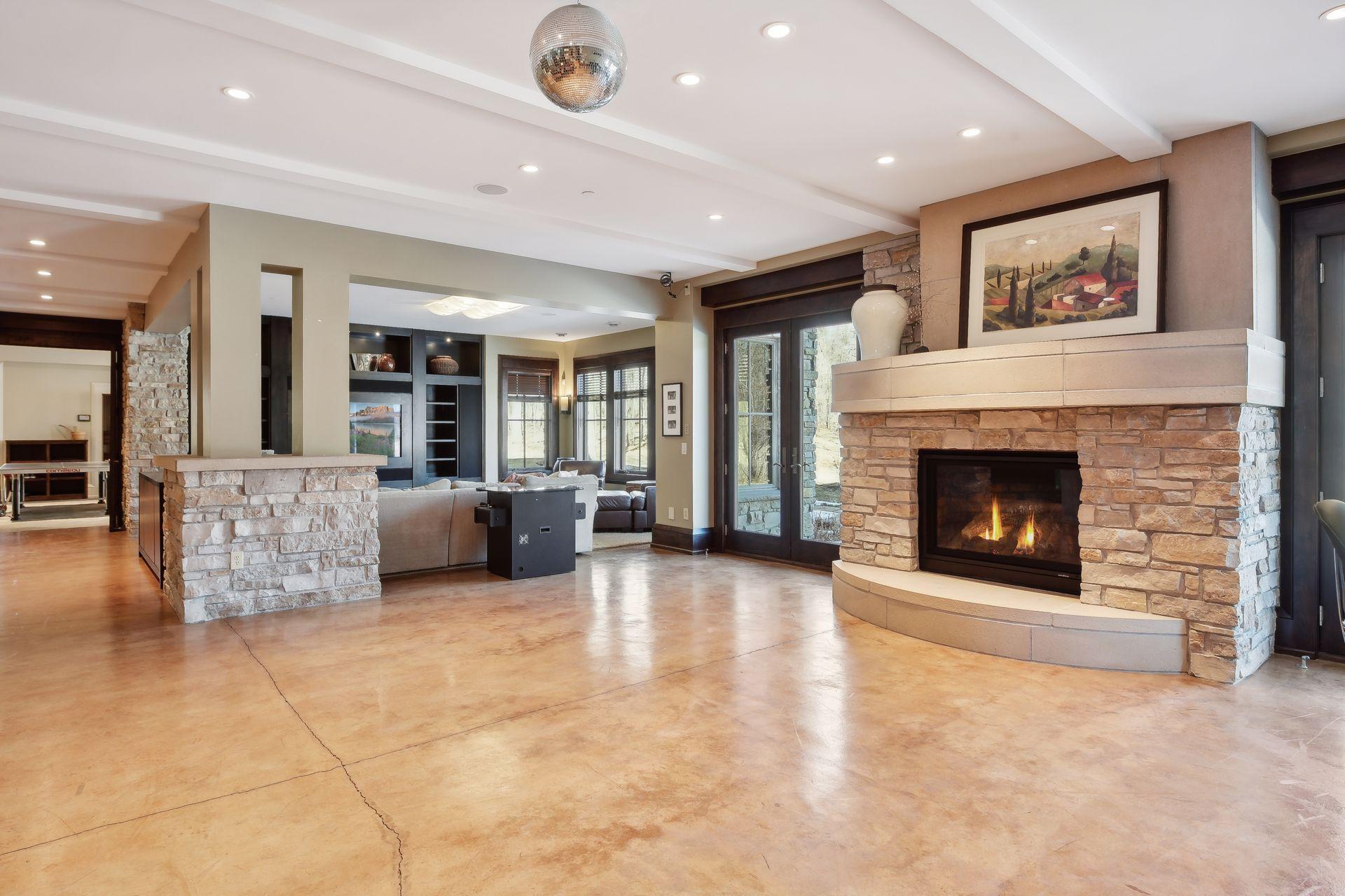 Double walk out with stone fireplace and dance floor area