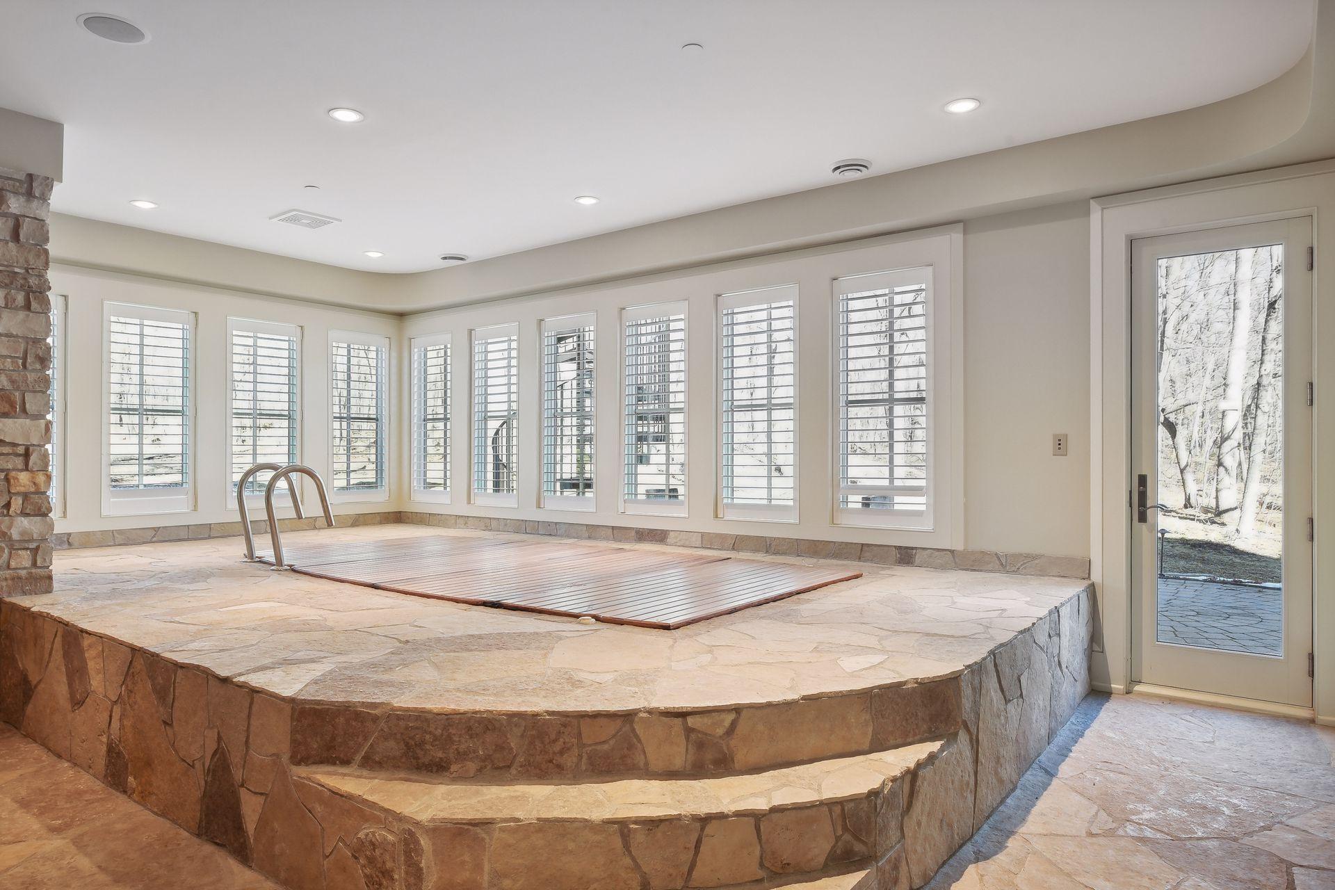 Lap pool with walk out to woods and 1/2 bath