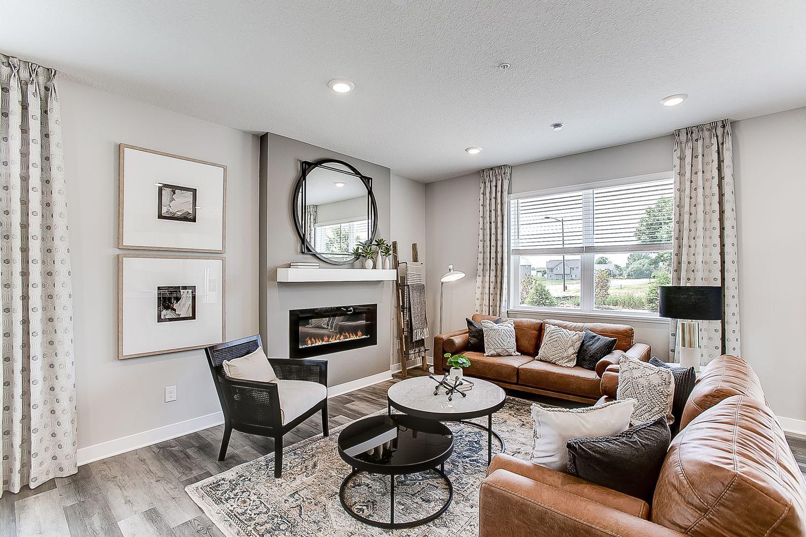 The fireplace looks very sleek and modern. *Photos of model home, colors and selections may vary.