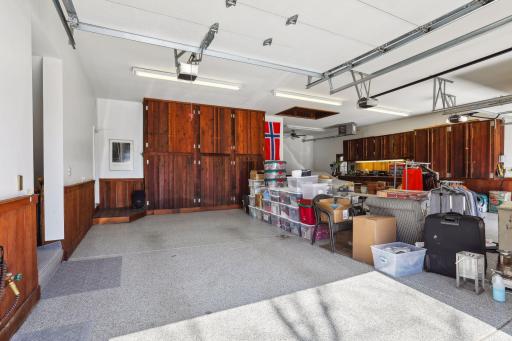 4 car garage - stall 1 has a Tesla supercharger. Hatch in the ceiling is a hoist lift to the bonus storage above -- also accessible by full size staircase (shown at back left of this photo)