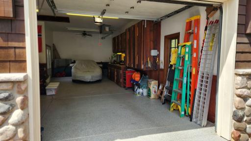 4 car garage - stalls 3 and 4 are tandem with workbench along the side and direct access to back yard and dog kennel just outside.