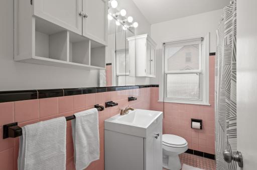 What a fun bathroom with retro tiles providing easy care, and a built in medicine cabinet for convenient storage.