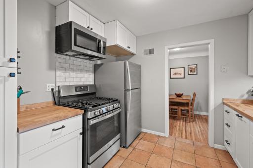 Stainless steel appliances and a gas range.
