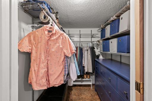 The walk-in closet with a pocket door to save valuable storage space.