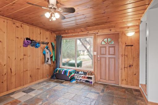 The breezeway offers a door to welcome guests and is accessible from the living room and kitchen. The tile floor means easy cleanup in winter months. The wood details are warm and give a rustic vibe.
