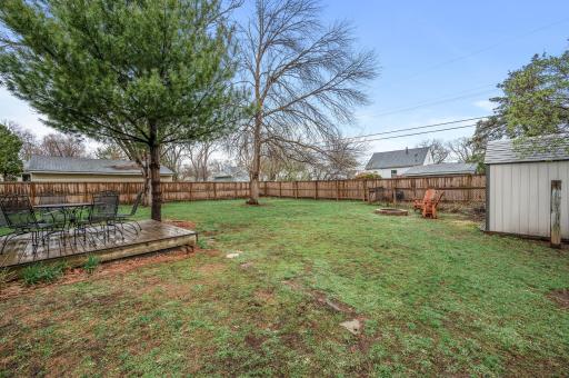What a spacious backyard. The wood fence provides privacy with lots of open space to play or relax in.