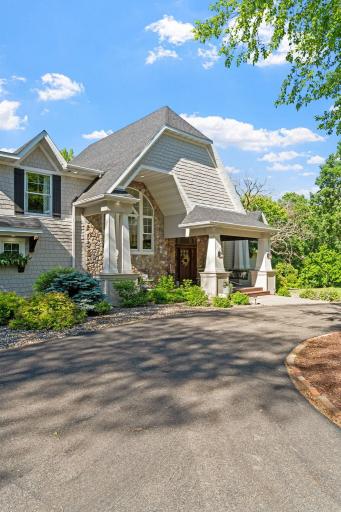 Hardie Board lap & shakes w/ river rock accented w/ charming corbels & window boxes