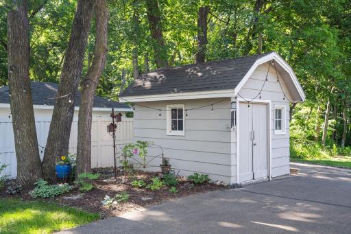 Storage shed by the house offers lots of space for outdoor equipment!