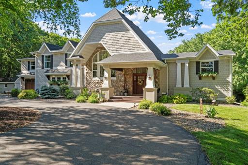 Enameled, maple, and cherry millwork, stone accents, three fireplaces, hardwood floors, dual laundry facilities and two kitchens!