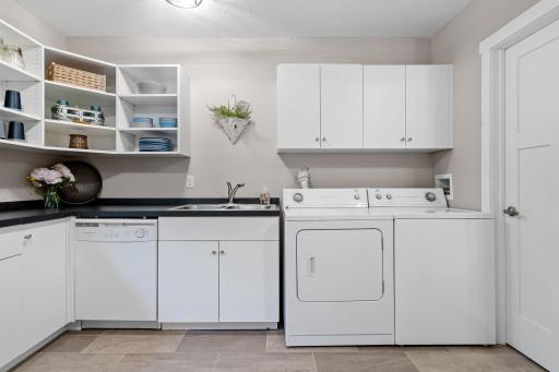 Lower level kitchen offers built-in laminated cabinetry w/ great counter space! Also, a 2nd pair of washer & dryer!