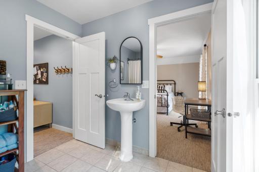 Charming pedestal sink & large window that provides great natural light