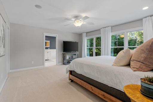 Primary Bedroom features vaulted ceilings w/ fan & dual recessed reading lights