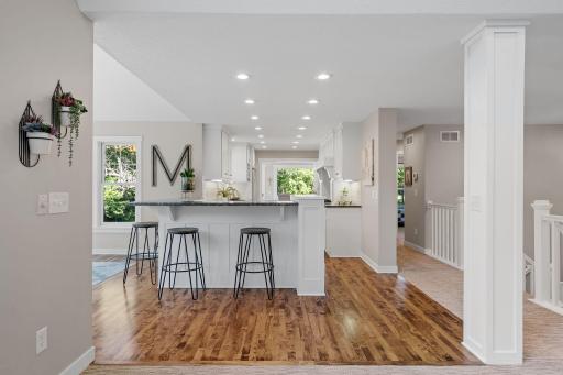Maple hardwood flooring finished in a warm walnut tone throughout the kitchen and dining room