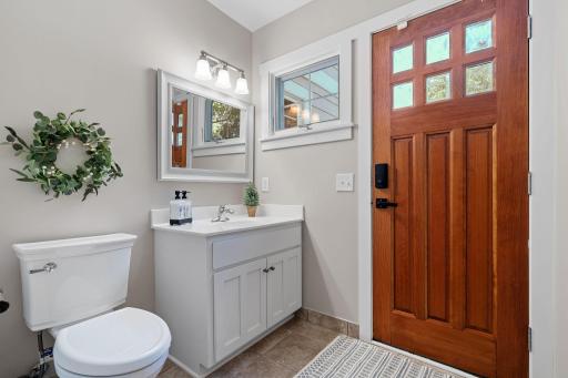 3/4 bathroom features enameled vanity cabinet and exterior entry door that is accessible from the patio & pool area!