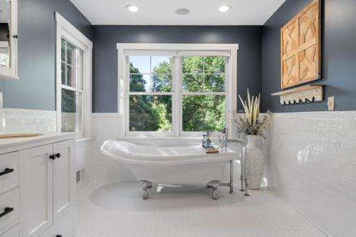 Cast iron clawfoot tub w/ "vintage" faucet & hand shower plus incredible views of the property!