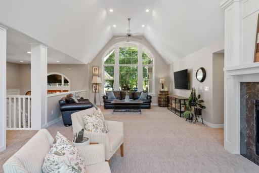 Decorative arched windows set atop large picture windows, front and back
