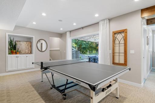 Full glass entry door opens up to concrete patio & pool