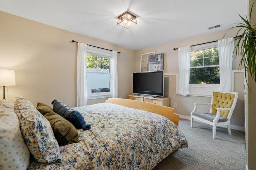 Bedroom 5 in the lower level features pair of windows offer natural light