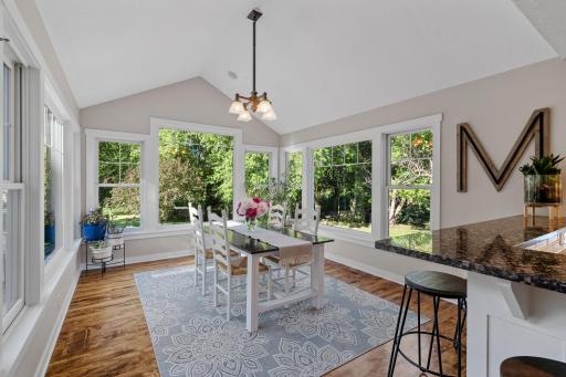 Dining Room features vaulted ceilings w/ recessed lighting and decorative floor to ceiling windows that capture incredible panoramic views of the property
