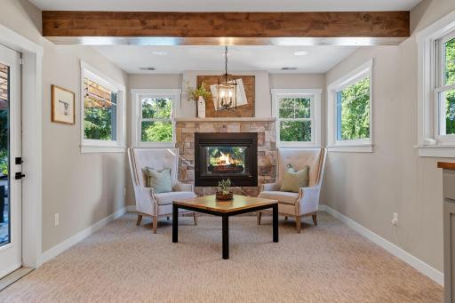 See-through gas fireplace w/ stone veneer surround & mantel in the sitting area