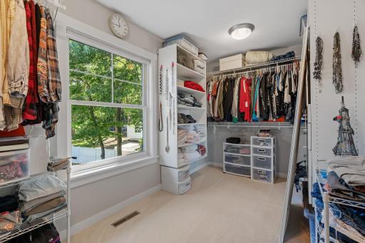 Spacious walk-in closet w/ professional storage system & natural light