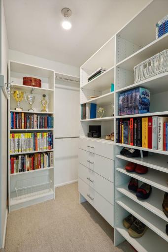 Large walk-in closet with custom shelving.