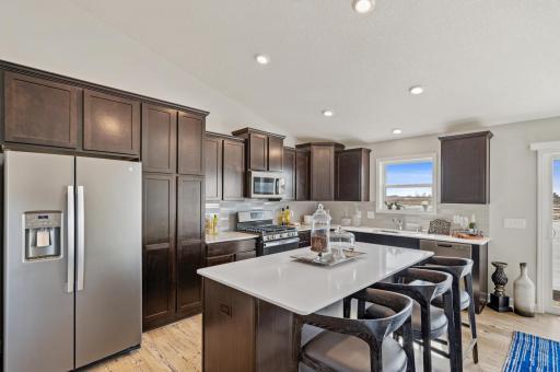 Imagine entertaining your friends and family in this functional, timeless design for years to come! Actual homes cabinets will be white. (Photo of a decorated model, actual homes finishes will vary)