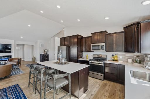 Each room flows into the next! Actual homes cabinets will be white. (Photo of a decorated model, actual homes finishes will vary)