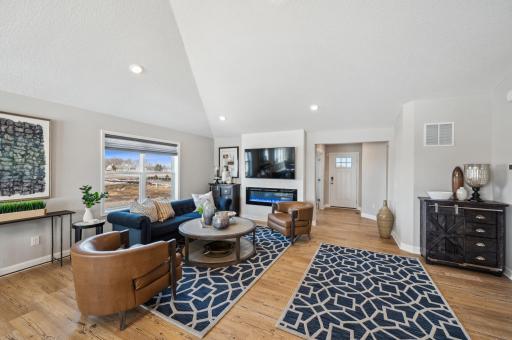 Cozy and contemporary, the main level family room includes a stunning electric fireplace. (Photo of a decorated model, actual homes finishes will vary)