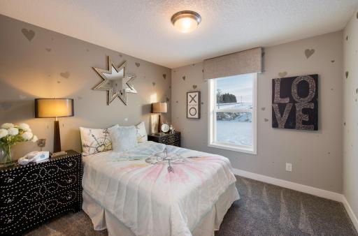 One of the three spacious secondary bedrooms. (Photo of a decorated model, actual homes finishes will vary)