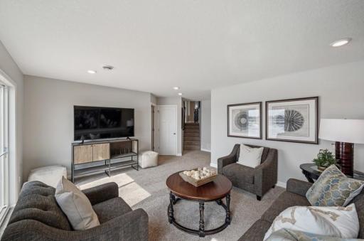 Lower level rec room - the perfect spot to gather! (Photo of a decorated model, actual homes finishes will vary)