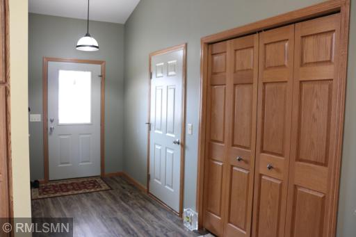 Spacious foyer with garage and hall coat closet.
